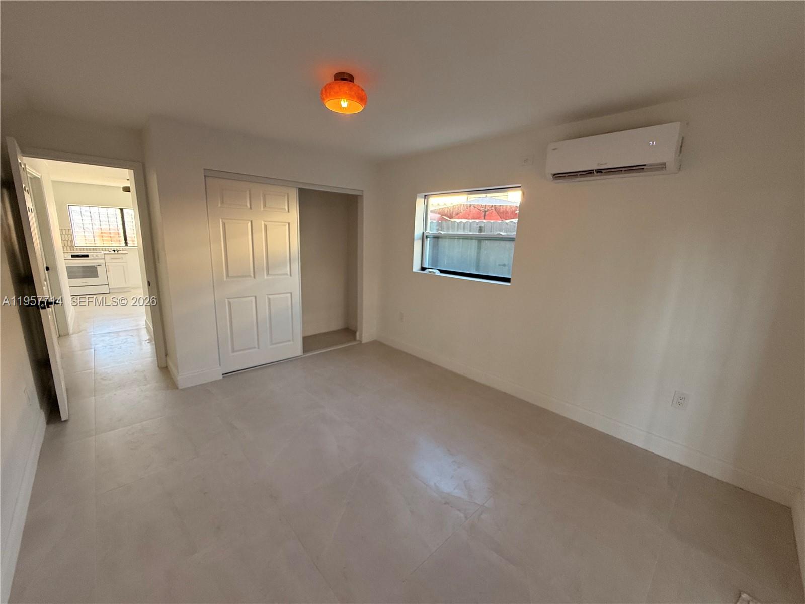525 Southwest 22nd Avenue, Unit B Miami, FL 33135 - Photo 11 of 13 an empty room with windows