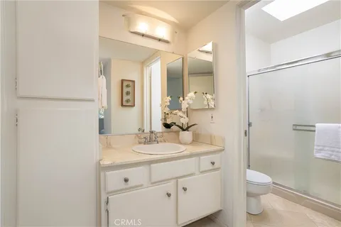 a bathroom with a toilet a sink and mirror