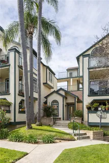 a front view of multiple houses with yard