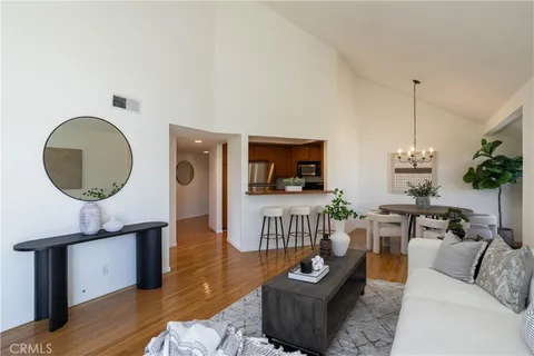 a living room with furniture a rug and a mirror