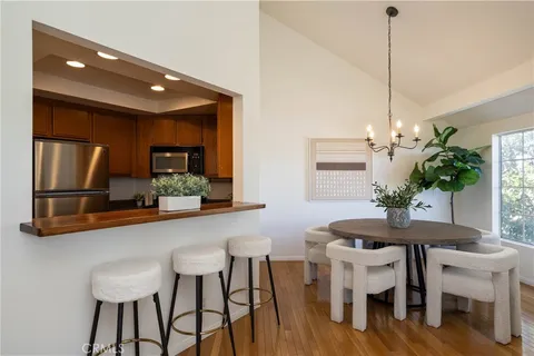 a dining room filled chandelier and wooden floor