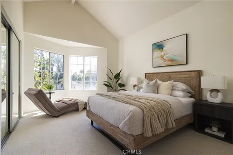 a bedroom with a bed and a couch