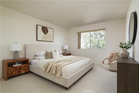 a bedroom with a bed wooden floor and window