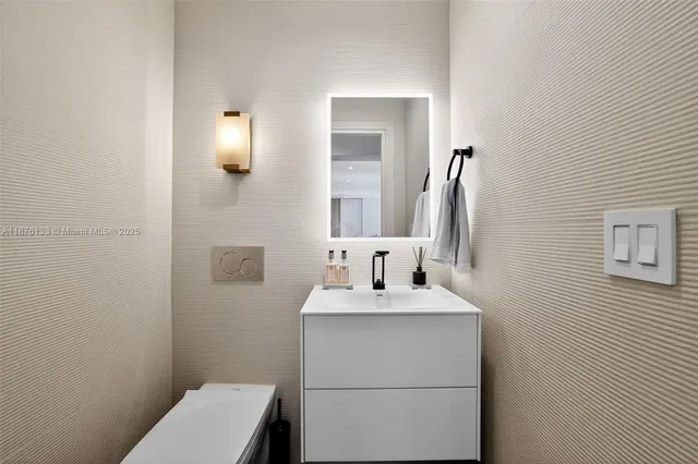 a bathroom with a sink a toilet and mirror