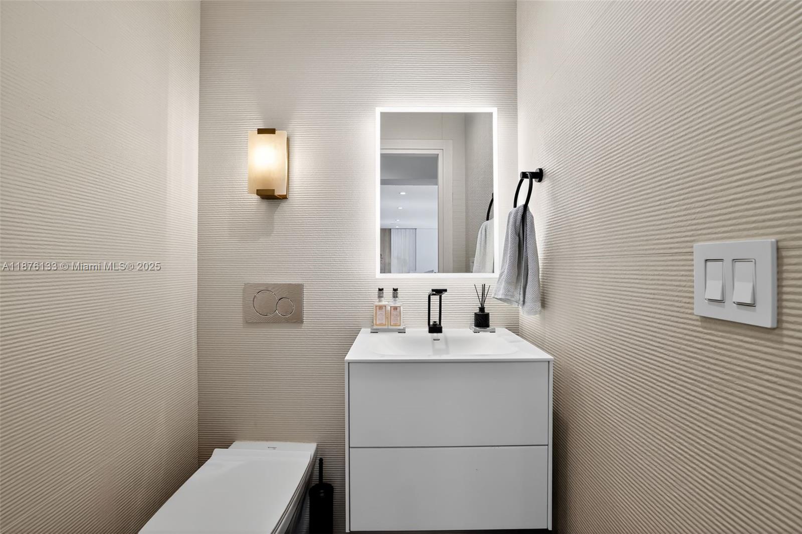 10740 Southwest 73rd Court Pinecrest, FL 33156 - Photo 14 of 37 a bathroom with a sink a toilet and mirror