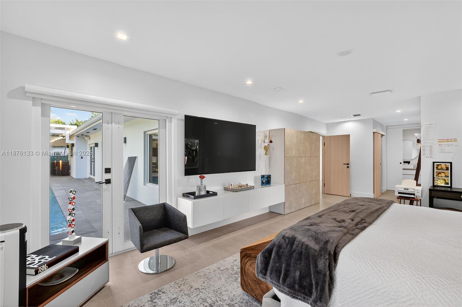 10740 Southwest 73rd Court Pinecrest, FL 33156 - Photo 16 of 37 a bedroom with a bed and a flat screen tv