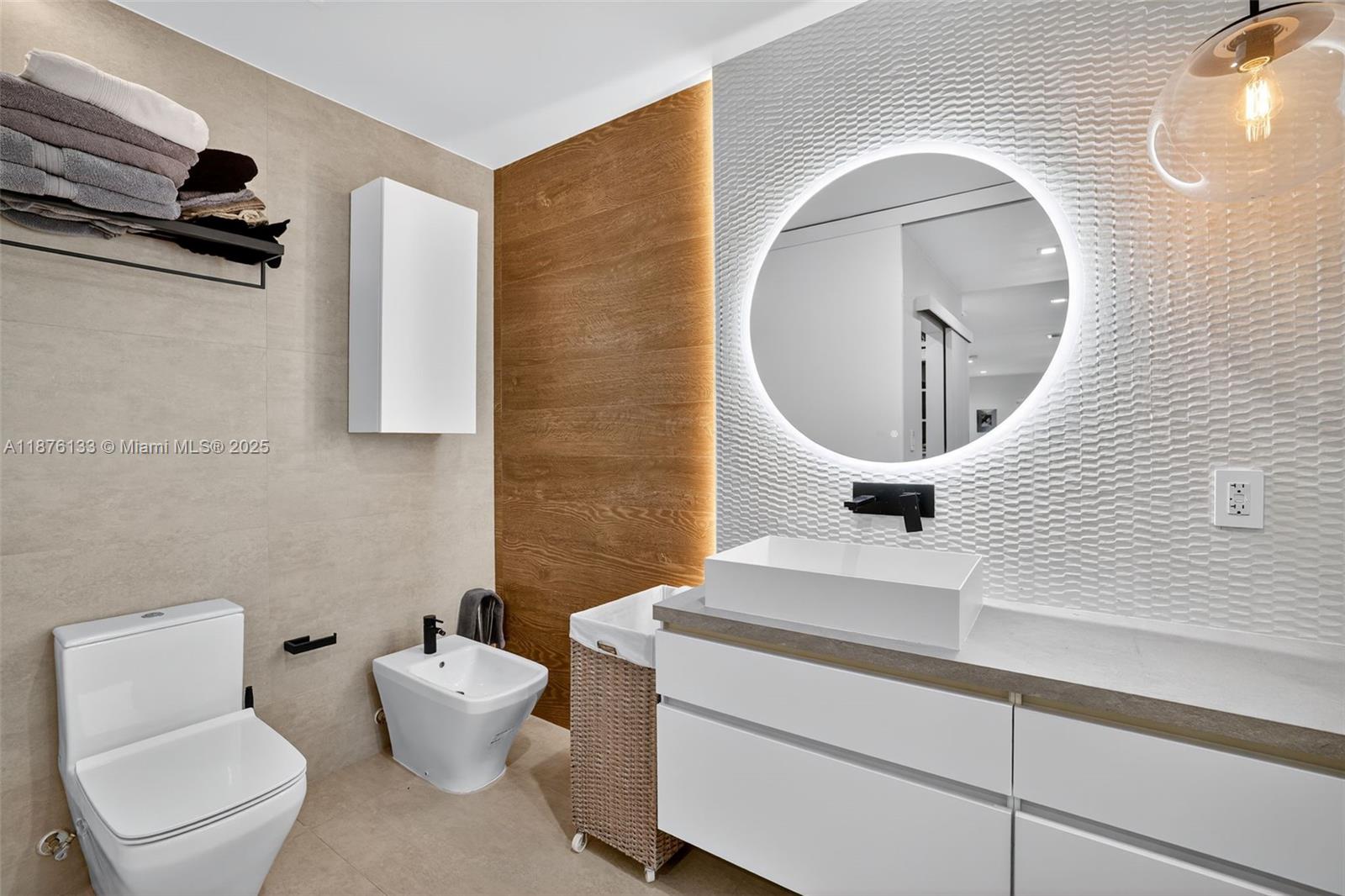 10740 Southwest 73rd Court Pinecrest, FL 33156 - Photo 18 of 37 a bathroom with a toilet a sink and mirror