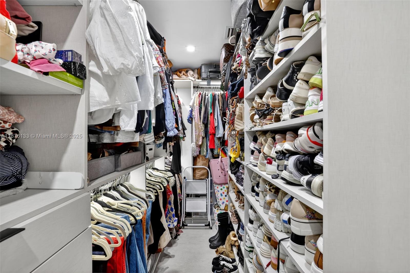 10740 Southwest 73rd Court Pinecrest, FL 33156 - Photo 20 of 37 a view of walk in closet with clothes and shoes