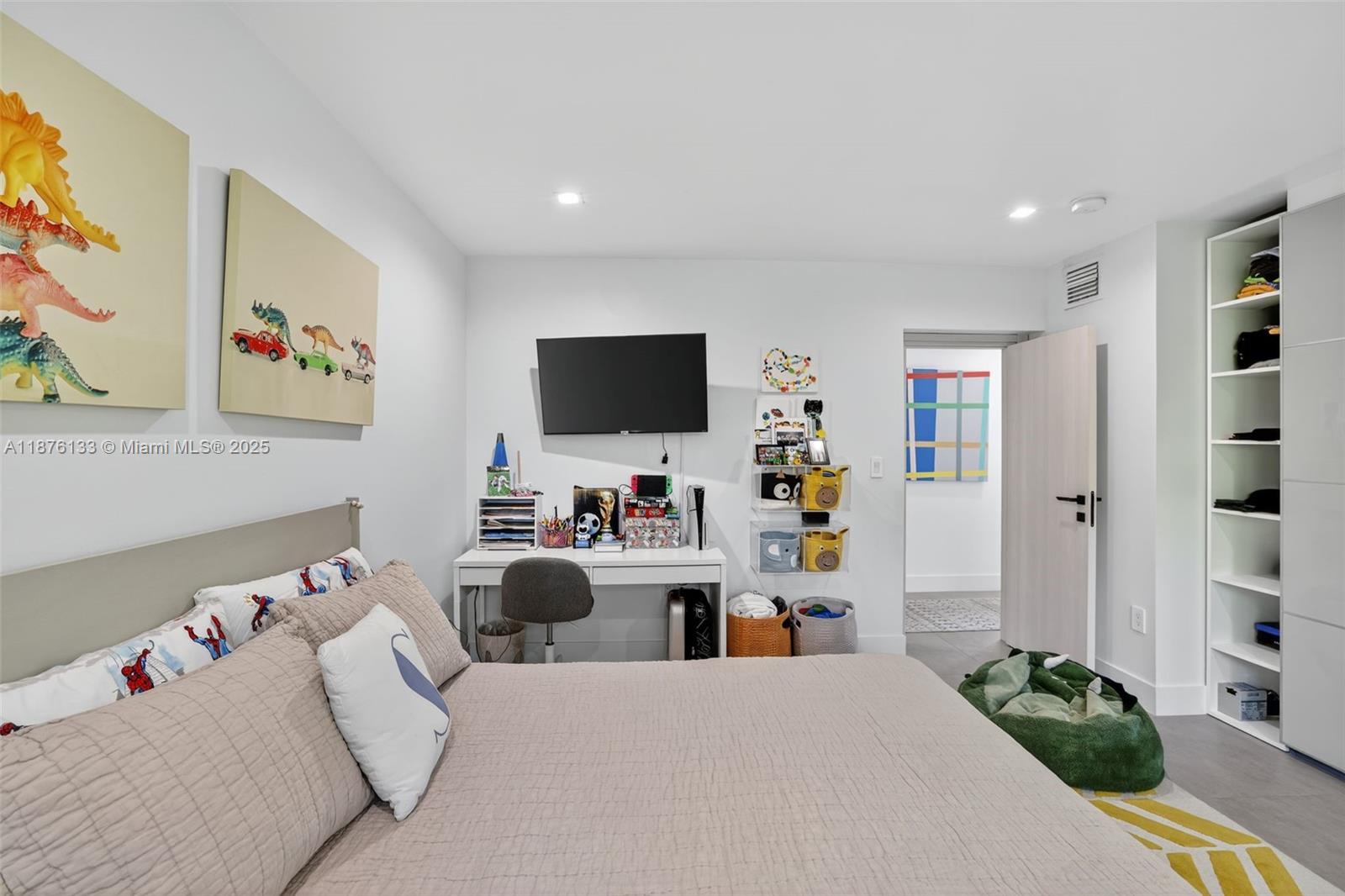 10740 Southwest 73rd Court Pinecrest, FL 33156 - Photo 21 of 37 a bedroom with a bed and a flat screen tv