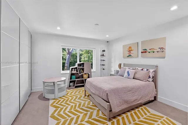 a bedroom with a bed and a view of bathroom