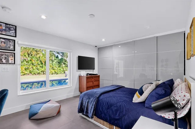 a bedroom with a bed and a television