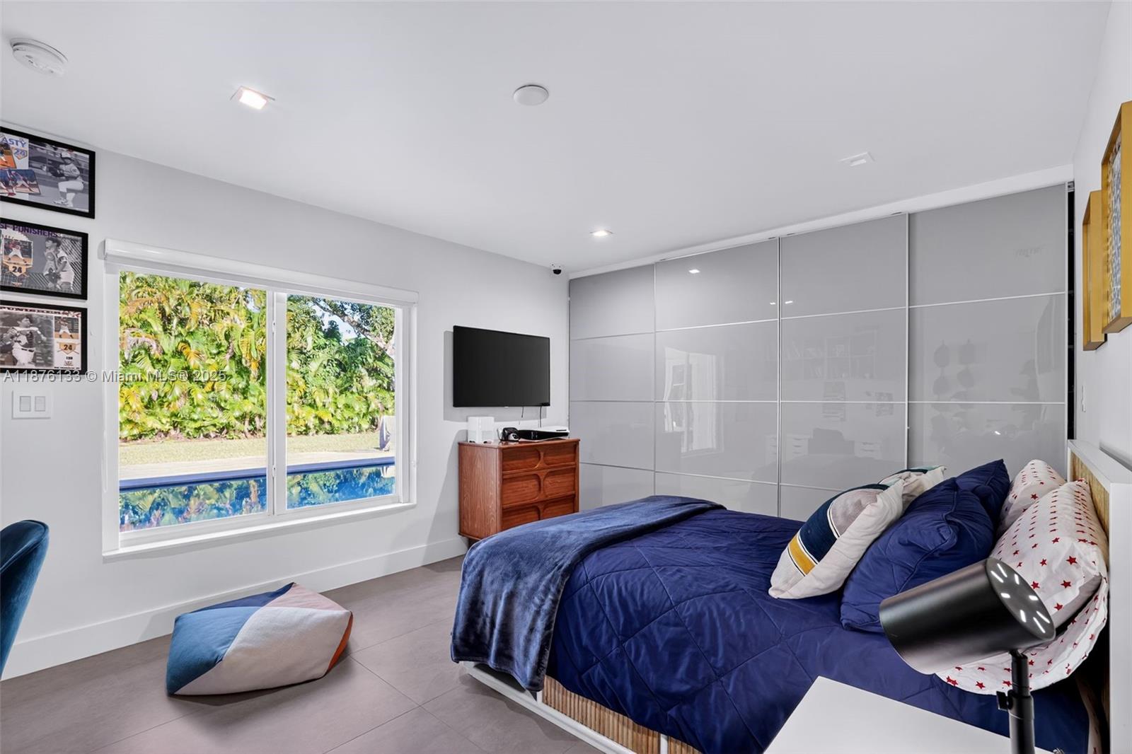 10740 Southwest 73rd Court Pinecrest, FL 33156 - Photo 26 of 37 a bedroom with a bed and a television