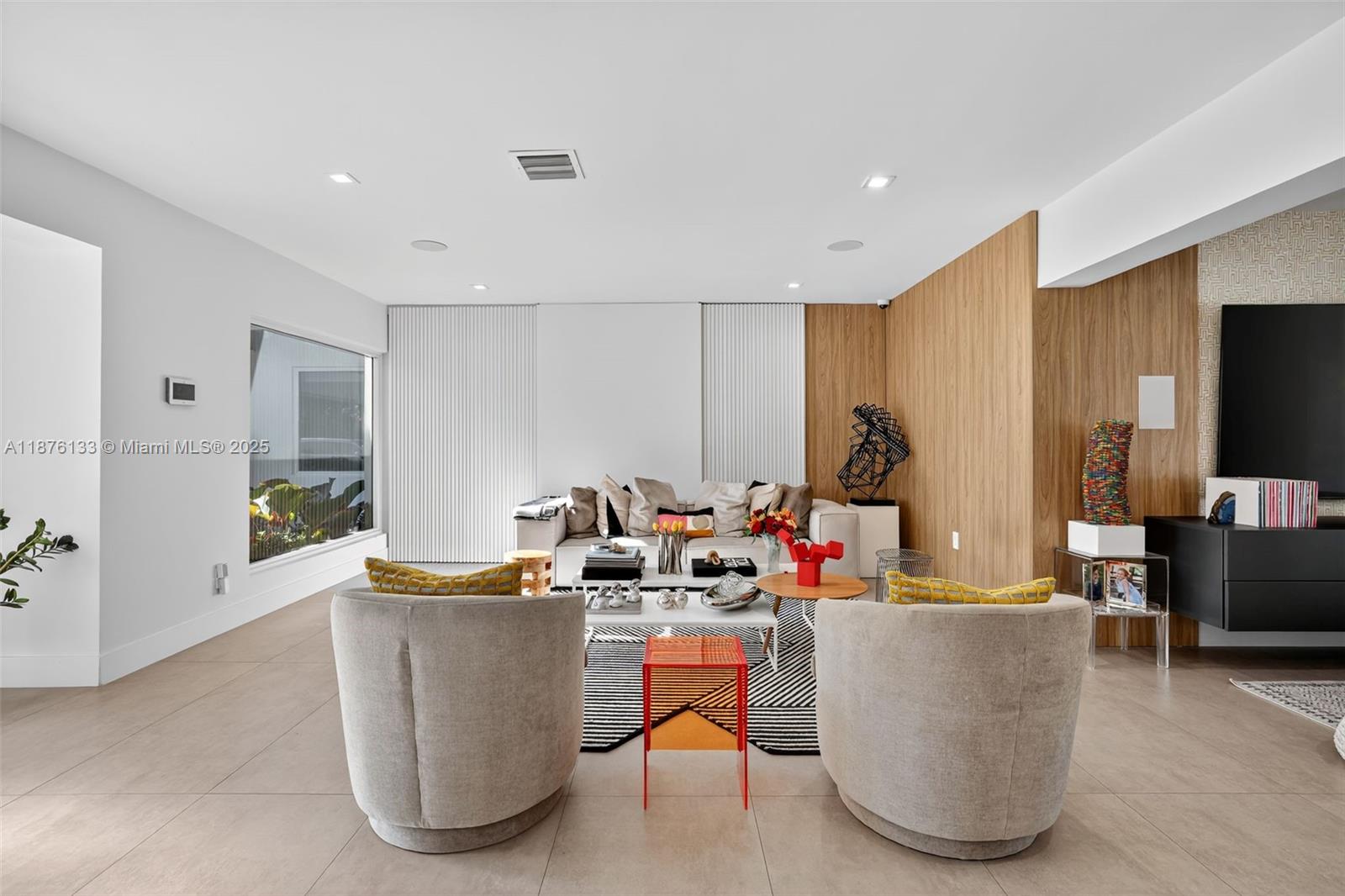 10740 Southwest 73rd Court Pinecrest, FL 33156 - Photo 3 of 37 a living room with furniture and a flat screen tv