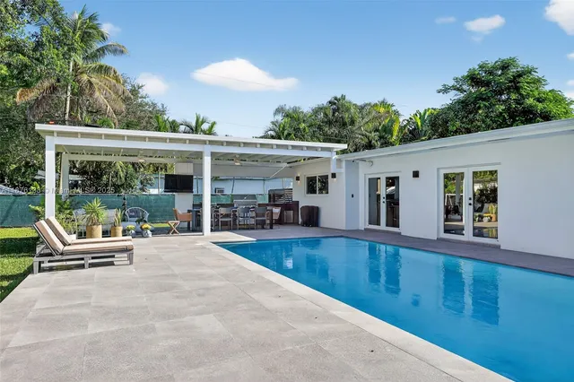 a view of a patio with swimming pool table and chairs