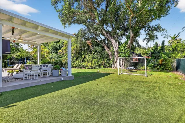 a view of backyard with sitting area