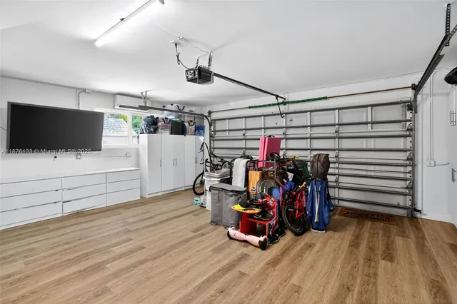 a view of a garage with furniture and a flat screen tv