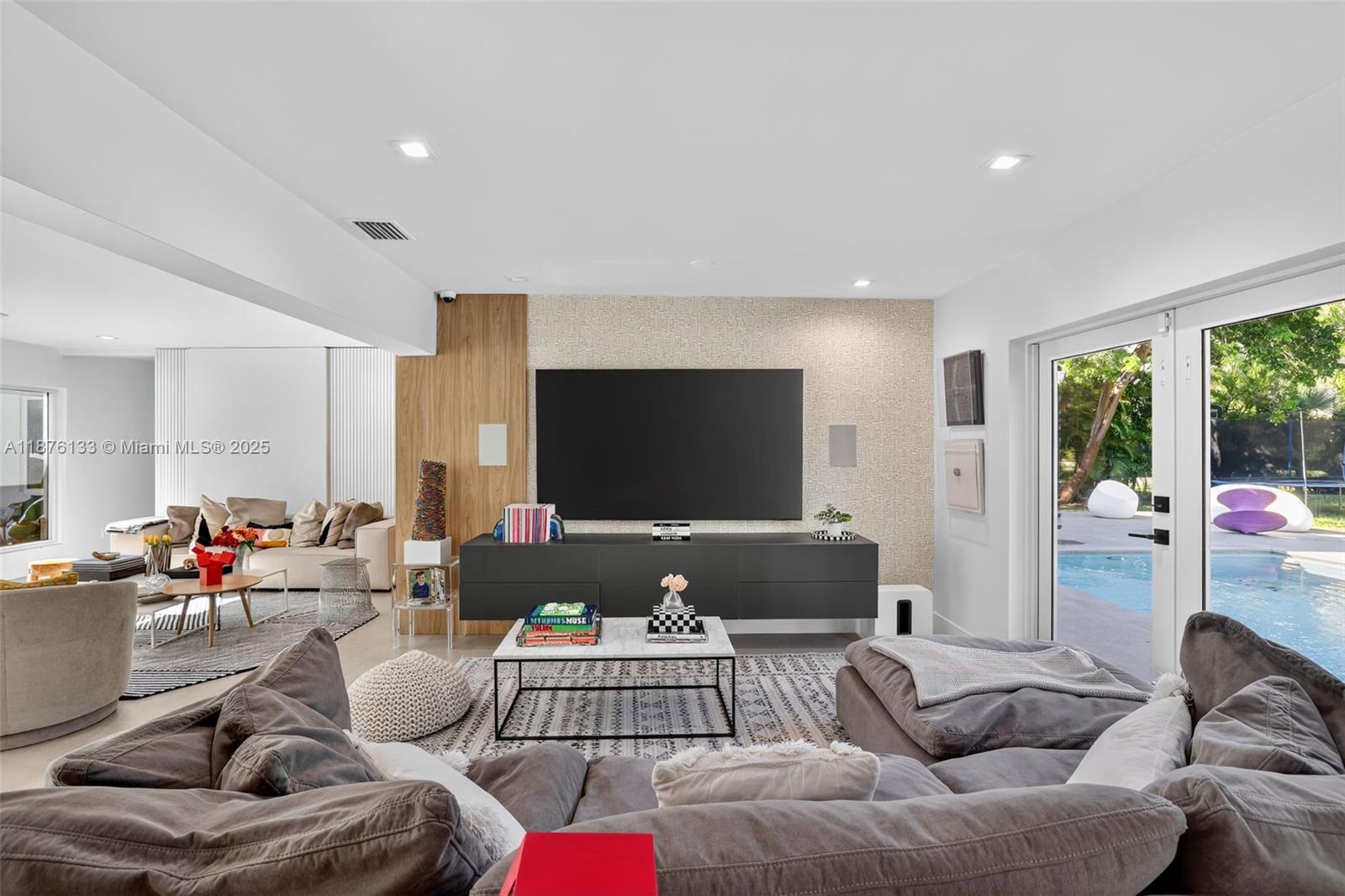 10740 Southwest 73rd Court Pinecrest, FL 33156 - Photo 4 of 37 a living room with furniture and a flat screen tv