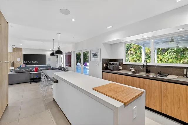 a kitchen with kitchen island a sink counter top space and a center island