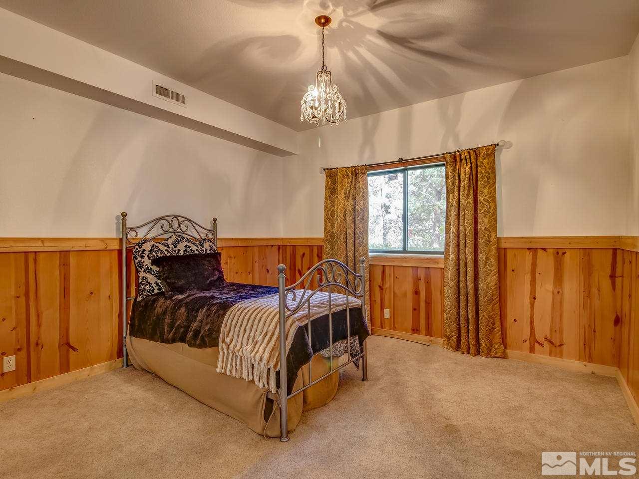 4125 Christy Way Reno, NV 89519 - Photo 12 of 23 a bed sitting in a bedroom next to a window