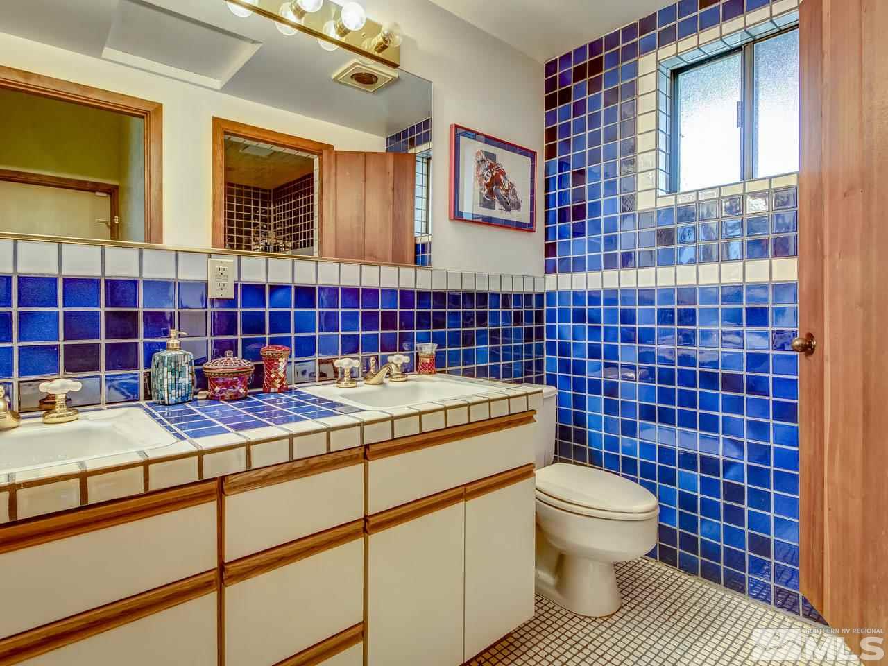 4125 Christy Way Reno, NV 89519 - Photo 13 of 23 a bathroom with a sink a toilet and shower
