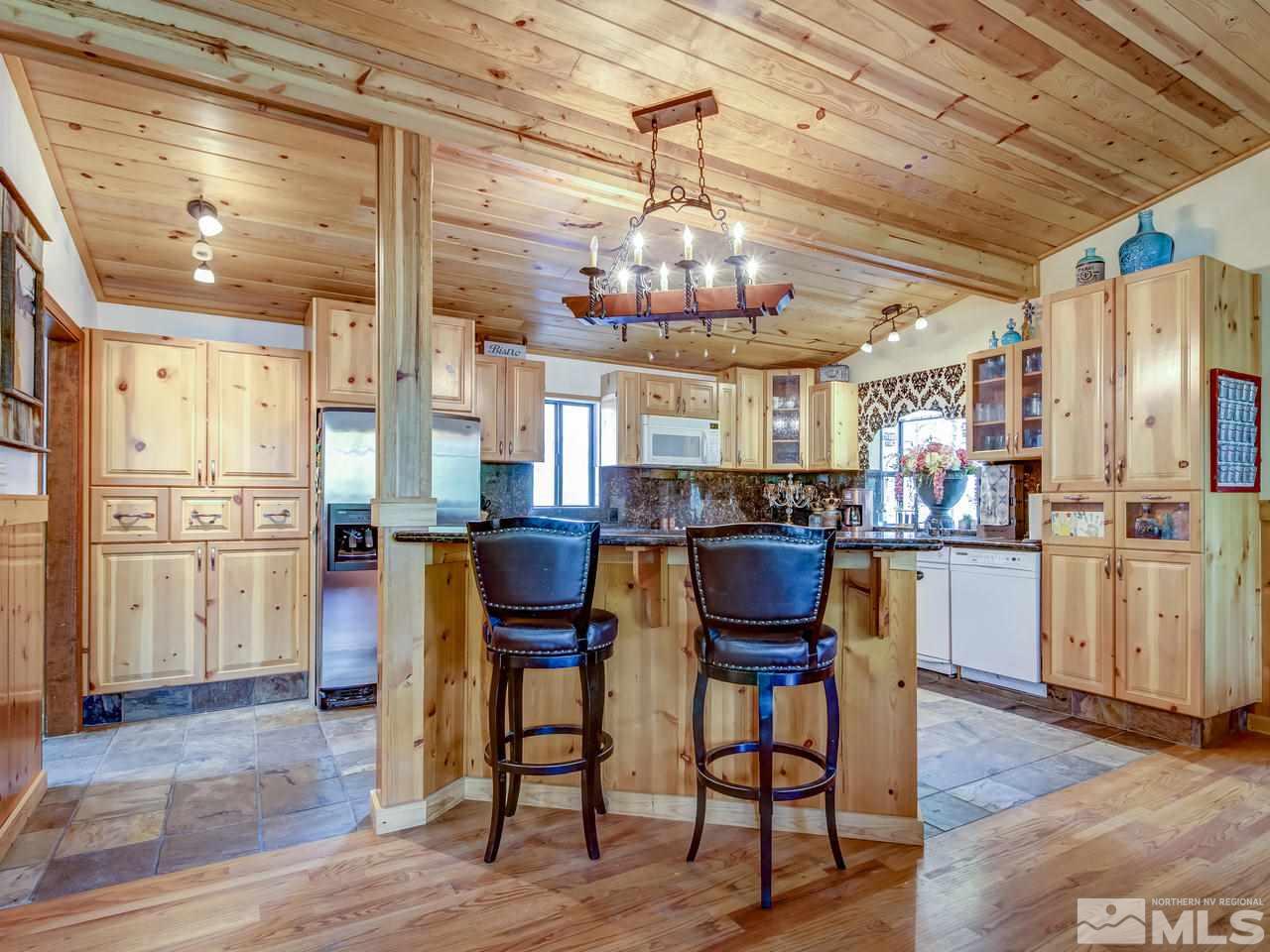 4125 Christy Way Reno, NV 89519 - Photo 4 of 23 a kitchen with refrigerator and chairs