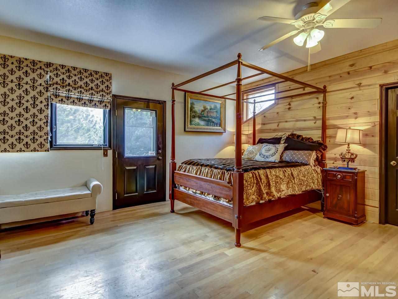 4125 Christy Way Reno, NV 89519 - Photo 5 of 23 a bedroom with a bed and a chandelier