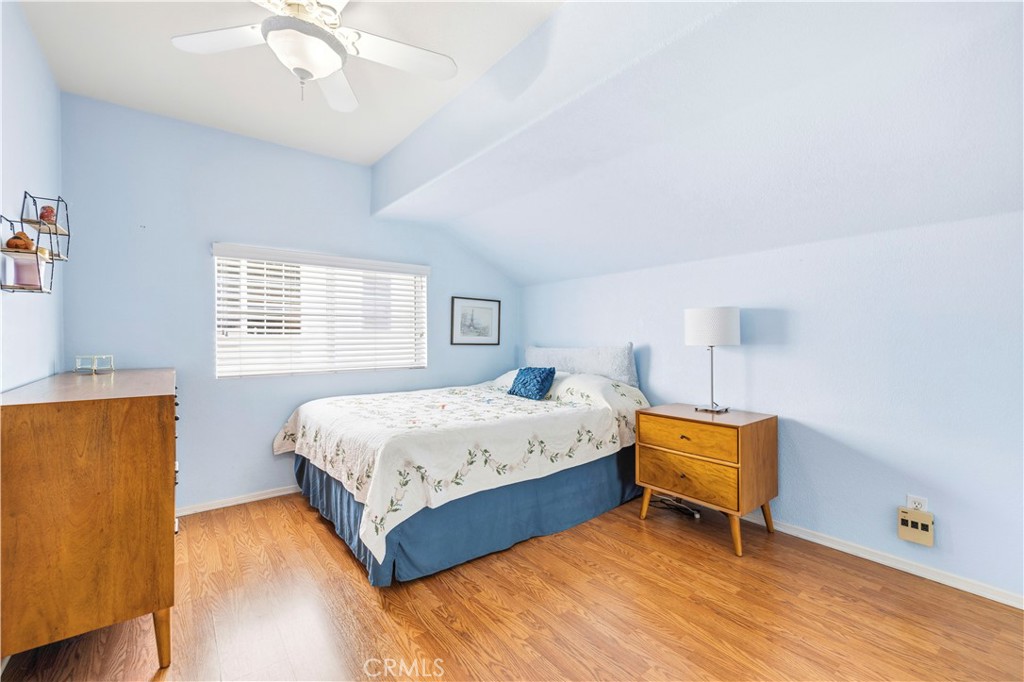 28033 Memory Lane Valencia, CA 91354 - Photo 22 of 40 a bedroom with a bed and a chandelier