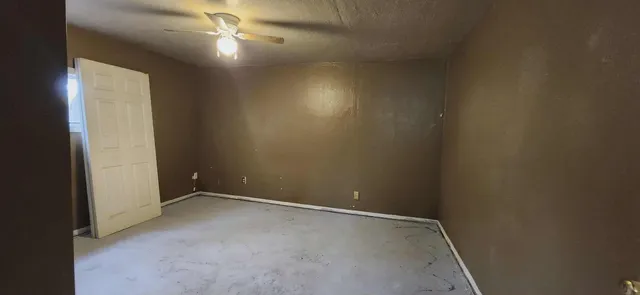 an empty room with windows and closet