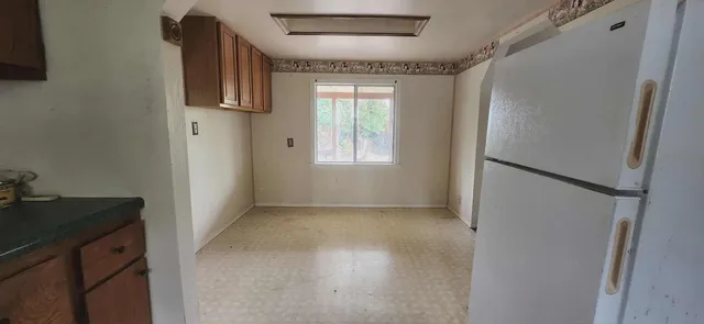 an empty room with closet and mirror
