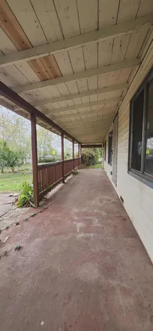 a view of a room with an empty space and next to a window
