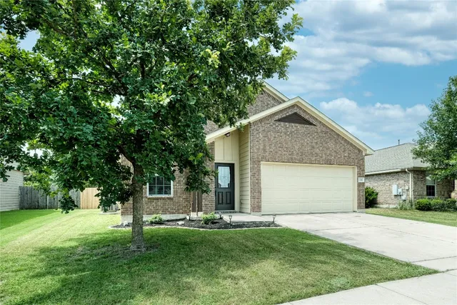 a front view of house with a garden