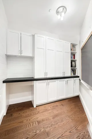 a spacious bathroom with a sink a toilet a mirror and shower