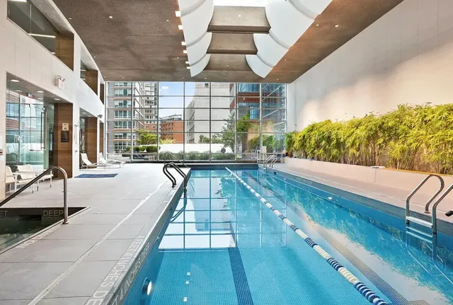 a swimming pool with outdoor seating and yard