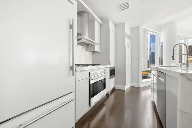 a living room with furniture fireplace and a large window