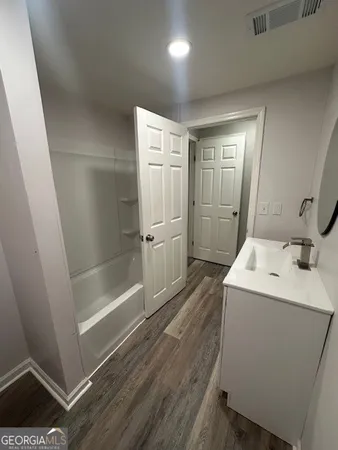 a bathroom with a sink and shower
