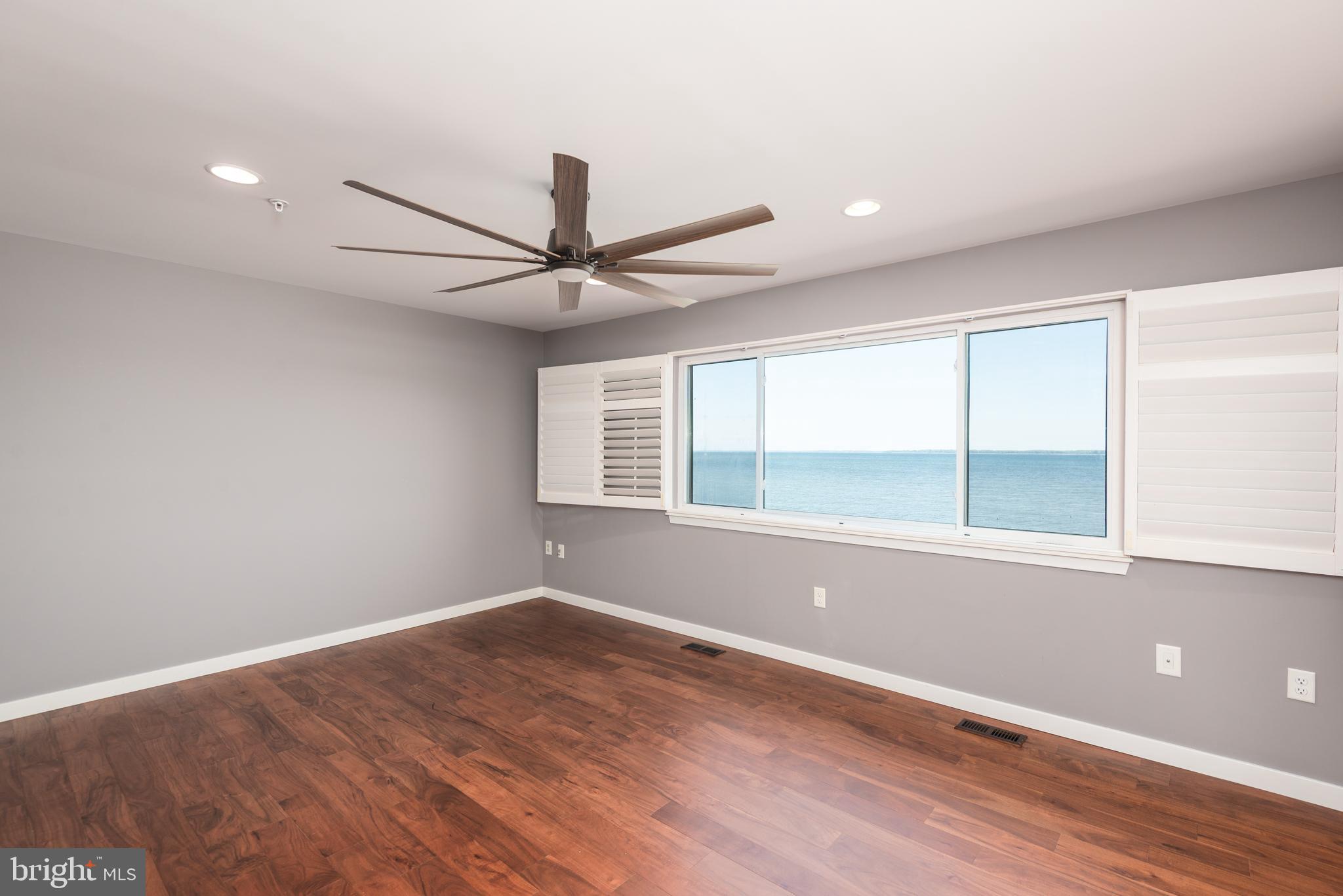 47 Queen Anne Way Chester, MD 21619 - Photo 26 of 44 an empty room with wooden floor and windows