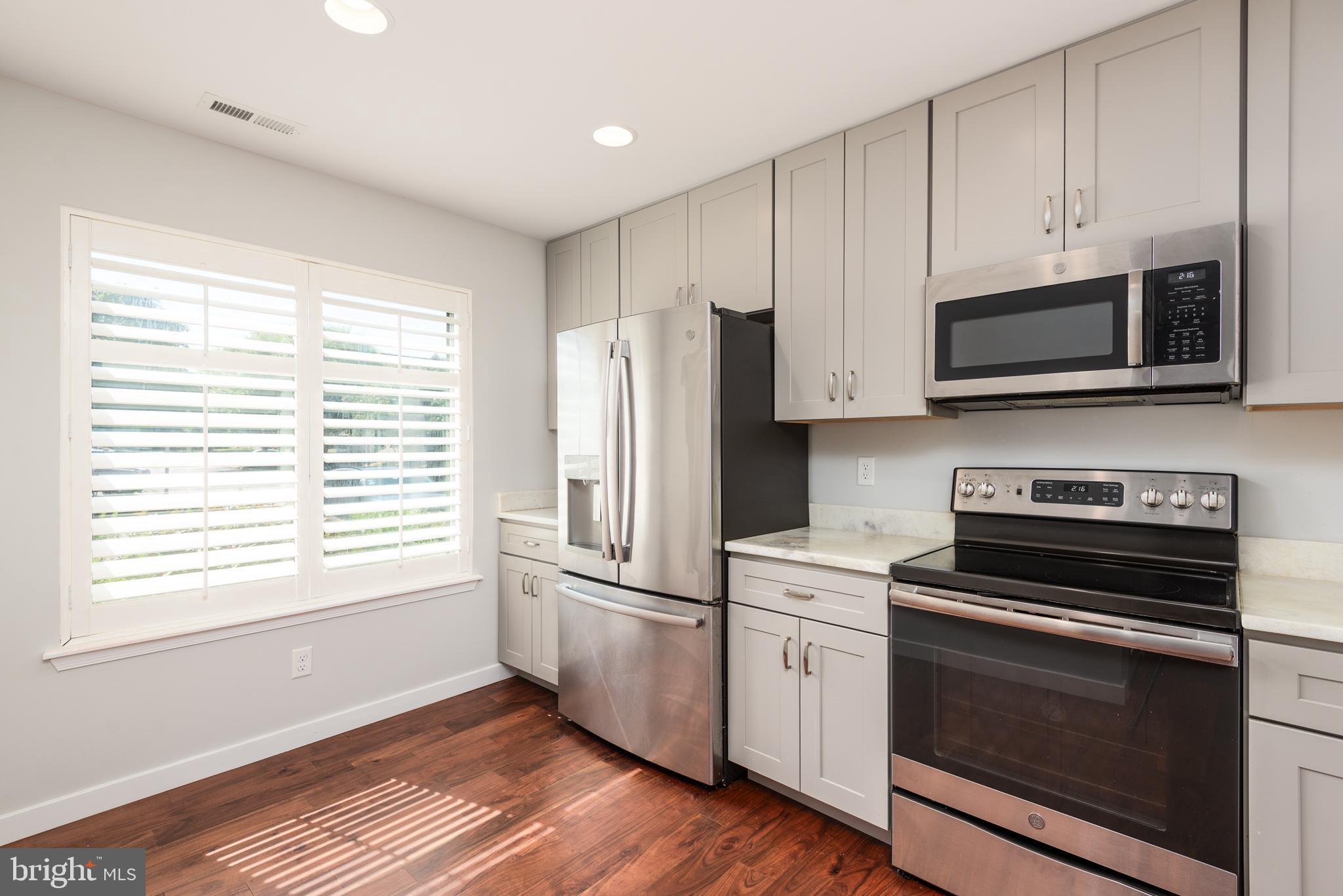 47 Queen Anne Way Chester, MD 21619 - Photo 30 of 44 a kitchen with stainless steel appliances white cabinets and a stove top oven