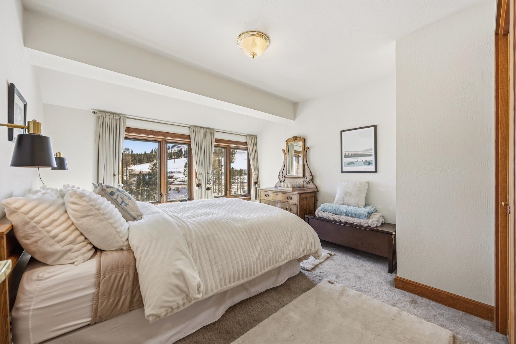 21501 Donner Pass Road, Unit 13 Soda Springs, CA 95728 - Photo 17 of 23 a bedroom with a bed and a chandelier