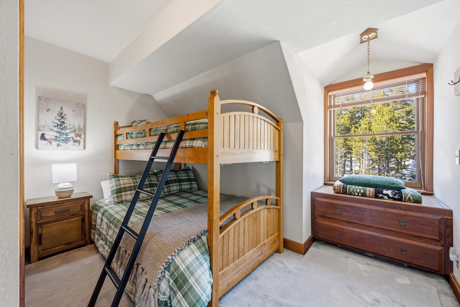 21501 Donner Pass Road, Unit 13 Soda Springs, CA 95728 - Photo 18 of 23 a bedroom with furniture and a window