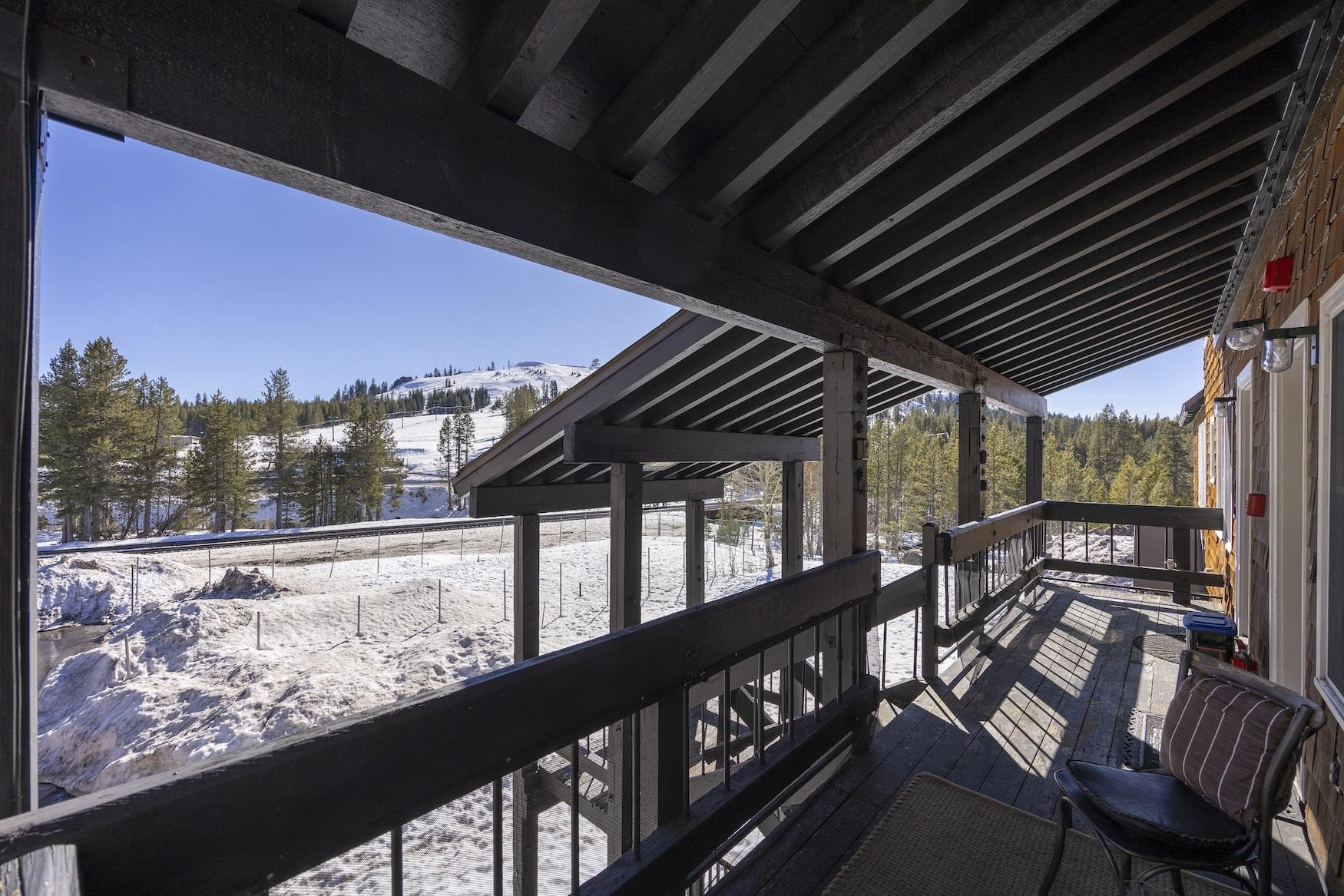 21501 Donner Pass Road, Unit 13 Soda Springs, CA 95728 - Photo 23 of 23 a view of a porch with furniture and wooden floor