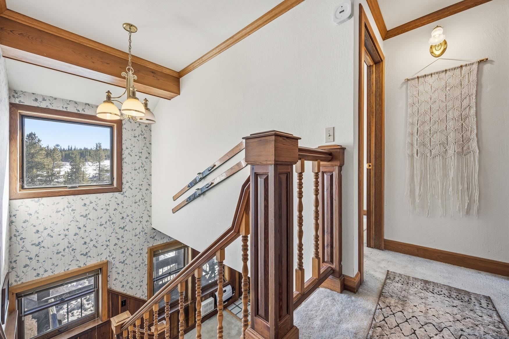 21501 Donner Pass Road, Unit 13 Soda Springs, CA 95728 - Photo 23 of 23 a view of a hallway with wooden floor and stairs