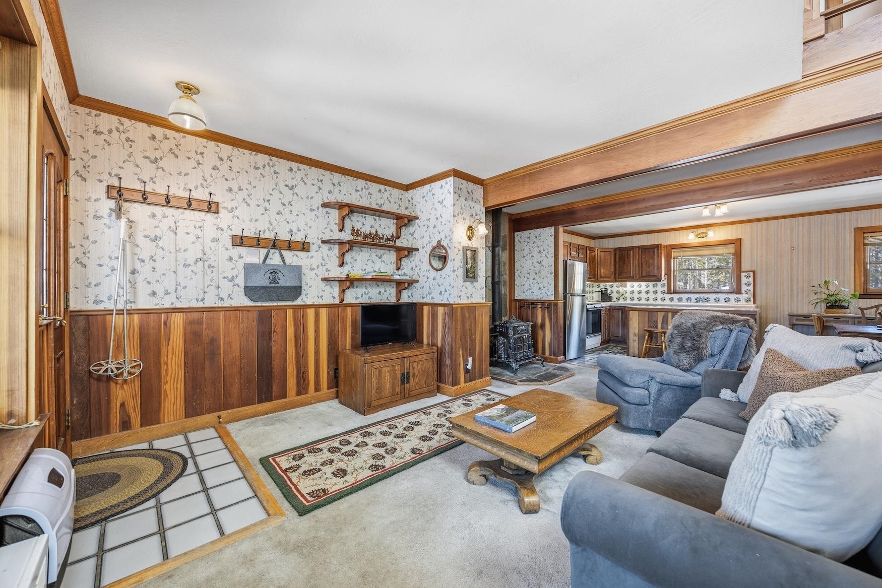 21501 Donner Pass Road, Unit 13 Soda Springs, CA 95728 - Photo 4 of 23 a living room with furniture and a table