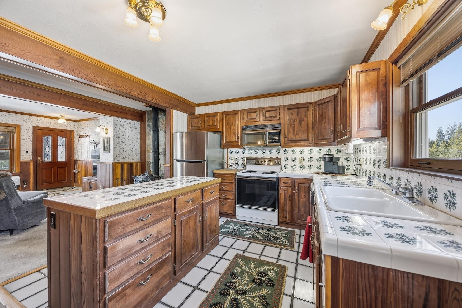 21501 Donner Pass Road, Unit 13 Soda Springs, CA 95728 - Photo 10 of 23 a kitchen with a stove a sink and a refrigerator