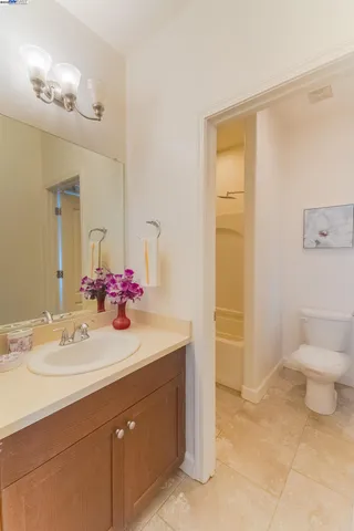 a white toilet sitting next to a bath tub