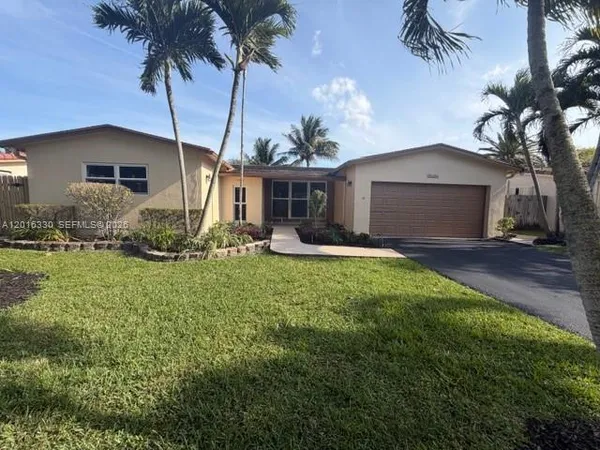 a front view of house with yard and trees