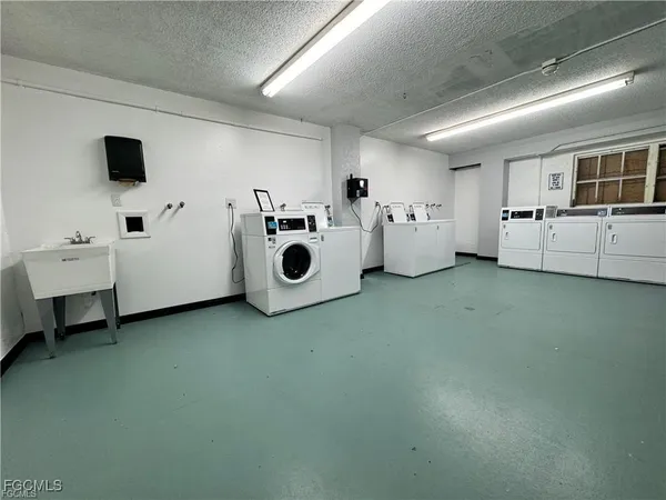 a utility room with multiple dryer and washer