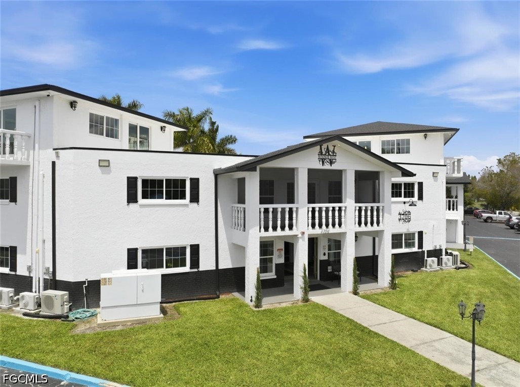 3706 Broadway, Unit 29 Fort Myers, FL 33901 - Photo 15 of 15 a front view of a house with a yard