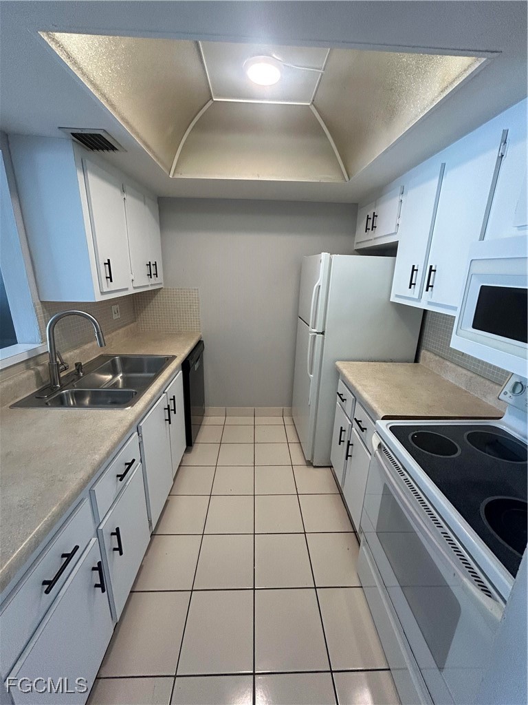 3706 Broadway, Unit 29 Fort Myers, FL 33901 - Photo 5 of 15 a kitchen with granite countertop a stove a sink and a refrigerator