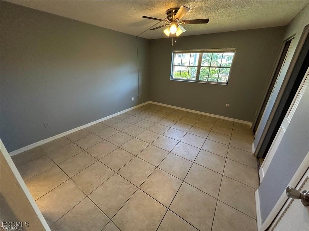 3706 Broadway, Unit 29 Fort Myers, FL 33901 - Photo 8 of 15 en empty room with windows and ceiling fan