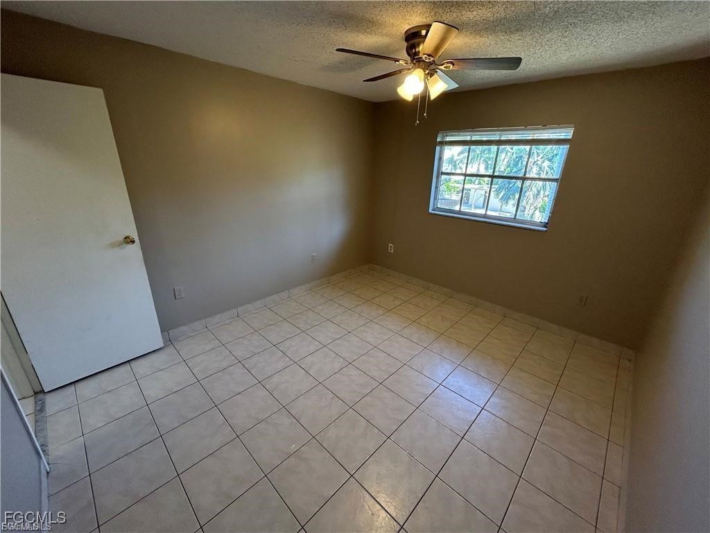 3706 Broadway, Unit 29 Fort Myers, FL 33901 - Photo 10 of 15 an empty room with windows and fan
